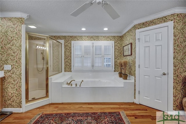 bathroom with wood finished floors and wallpapered walls