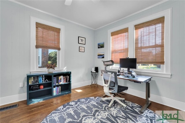 home office with ornamental molding, visible vents, plenty of natural light, and wood finished floors