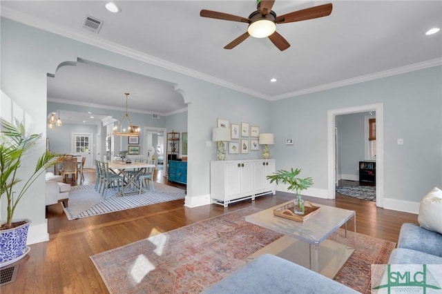 living room featuring dark wood-style floors, ornamental molding, recessed lighting, and baseboards