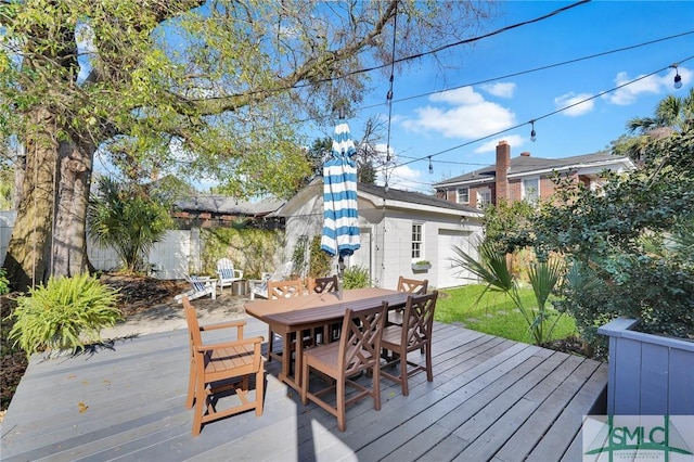 wooden terrace with outdoor dining space