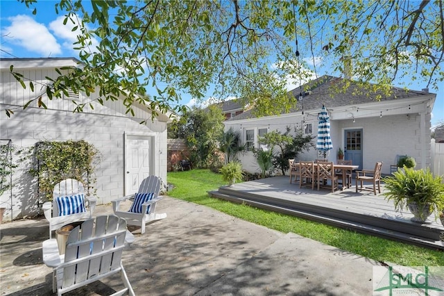 view of patio with outdoor dining space and a wooden deck