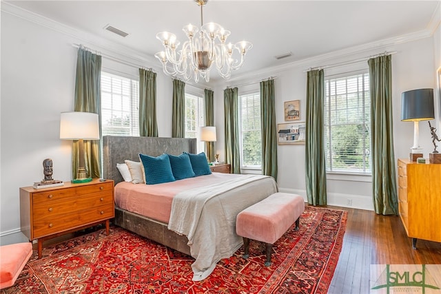 bedroom with dark wood-style floors, multiple windows, visible vents, and crown molding