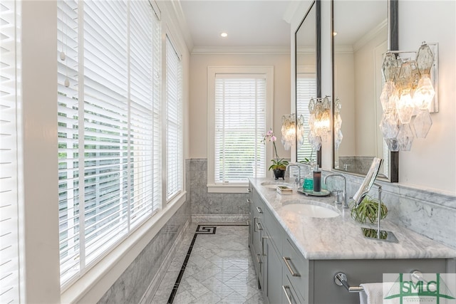 bathroom with a wainscoted wall, double vanity, a sink, and crown molding