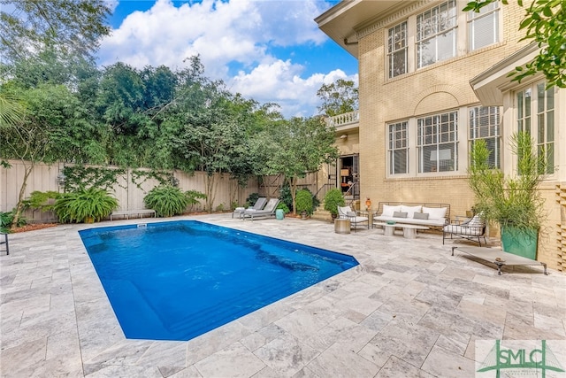 view of pool featuring a patio, outdoor lounge area, a fenced backyard, and a fenced in pool