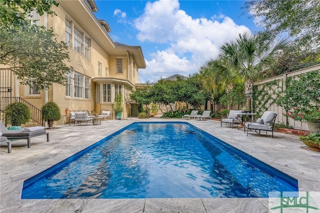 view of pool featuring fence, a fenced in pool, and a patio