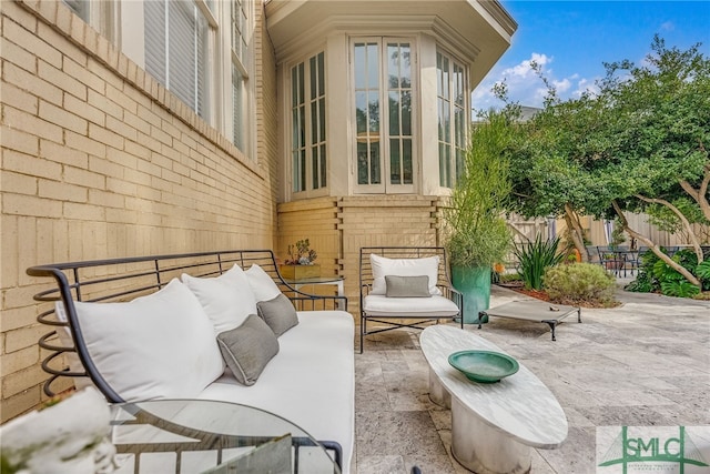 view of patio / terrace featuring outdoor lounge area and fence