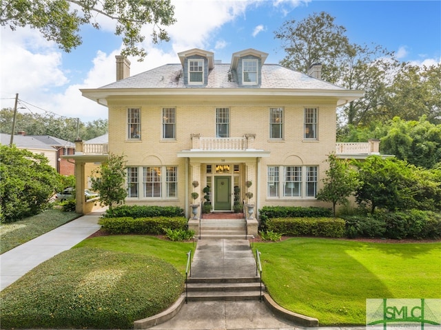 38 E 52nd St, Savannah, GA 31405 - colonial home featuring a chimney, a front yard, and a high end roof