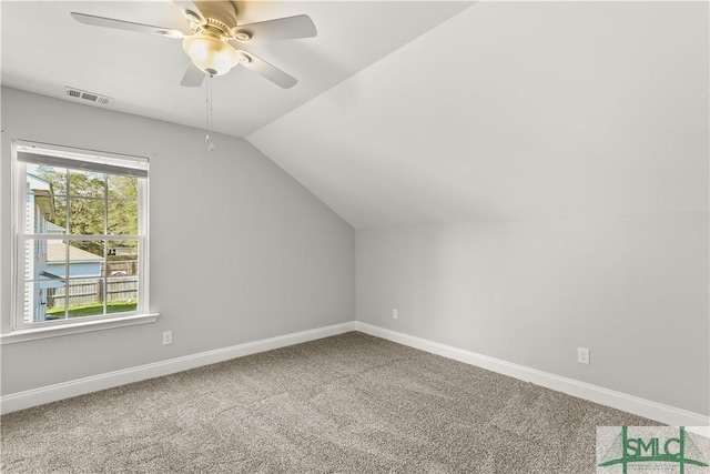 bonus room featuring lofted ceiling, ceiling fan, carpet floors, visible vents, and baseboards