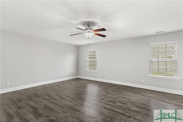 unfurnished room featuring ceiling fan, dark wood-style flooring, visible vents, and baseboards