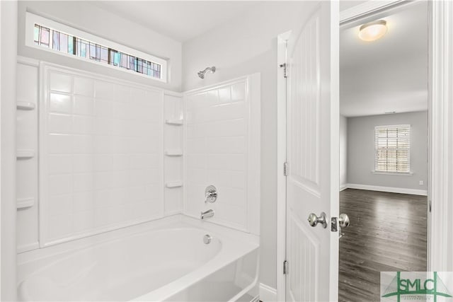 full bathroom with shower / bathing tub combination, baseboards, and wood finished floors