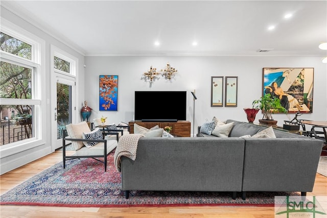 living room featuring visible vents, ornamental molding, wood finished floors, and recessed lighting