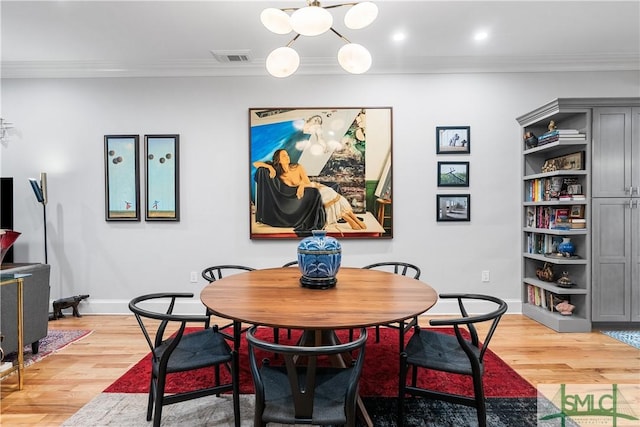 dining room with baseboards, light wood-type flooring, visible vents, and crown molding