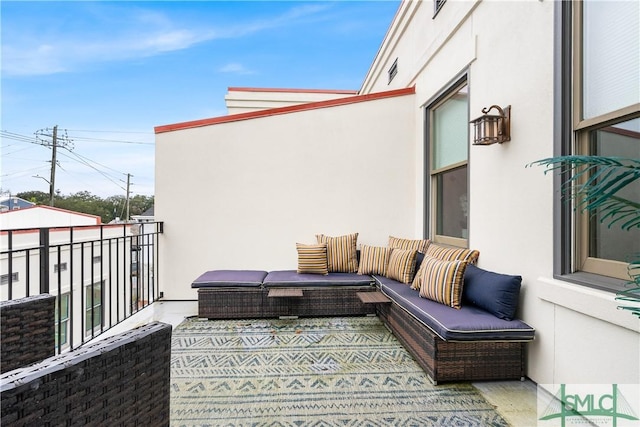 view of patio featuring an outdoor living space and a balcony