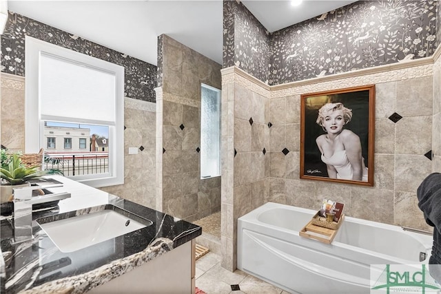 full bath featuring tile walls and wallpapered walls