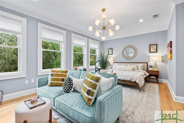 bedroom featuring a notable chandelier, visible vents, baseboards, light wood-type flooring, and crown molding