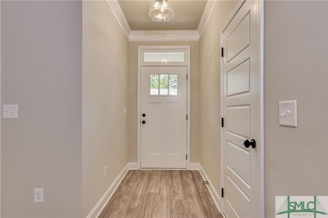 entryway featuring light wood finished floors, baseboards, and crown molding