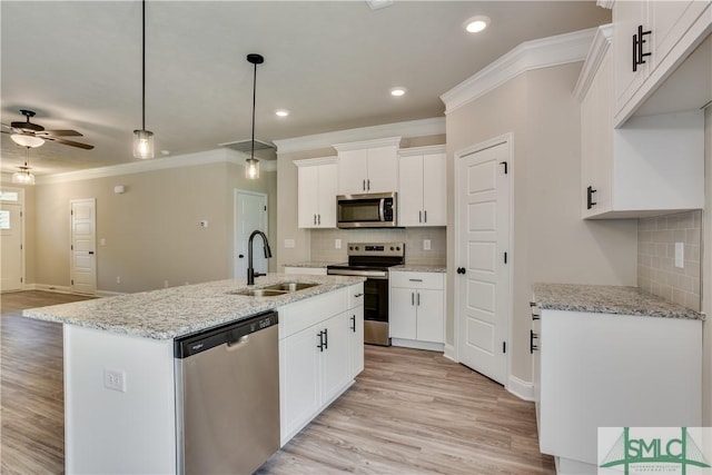 kitchen featuring light wood-style flooring, ceiling fan, appliances with stainless steel finishes, crown molding, and a sink