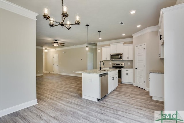 kitchen featuring stainless steel appliances, a sink, backsplash, and ornamental molding