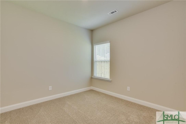 unfurnished room with light carpet, visible vents, and baseboards