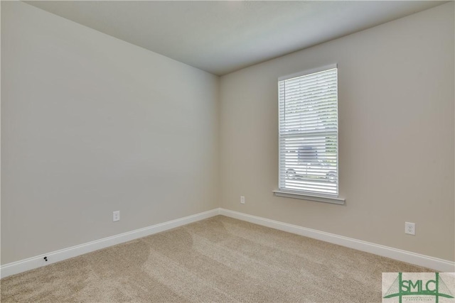 empty room with light carpet and baseboards