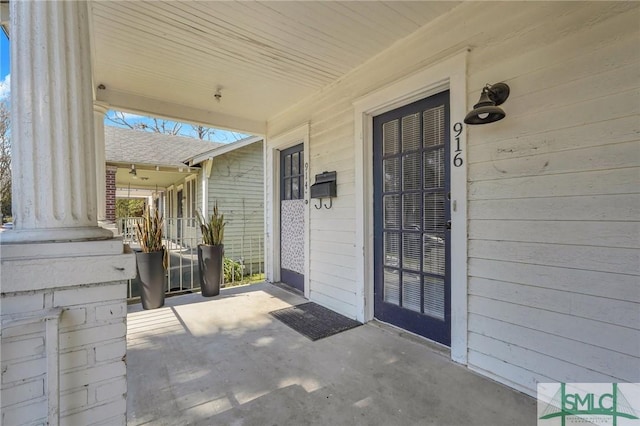 view of exterior entry featuring a porch