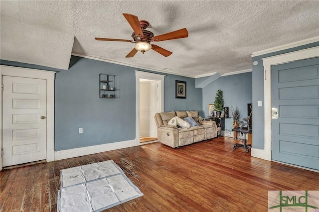 unfurnished living room with ornamental molding, wood-type flooring, baseboards, and a ceiling fan