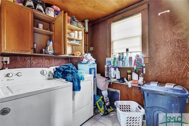 washroom with light tile patterned floors, wood ceiling, washing machine and clothes dryer, and cabinet space