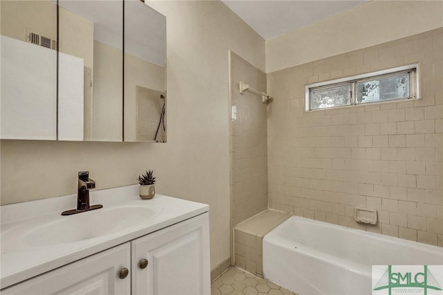 full bath with shower / tub combination, vanity, visible vents, and tile patterned floors