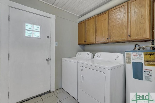 laundry area featuring cabinet space, water heater, washer and clothes dryer, and light tile patterned flooring