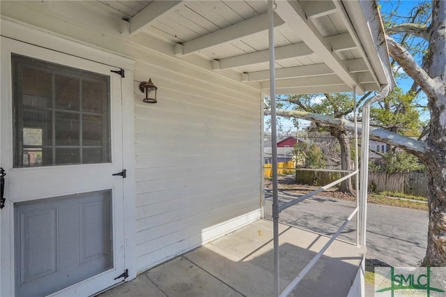 entrance to property with a patio area and fence