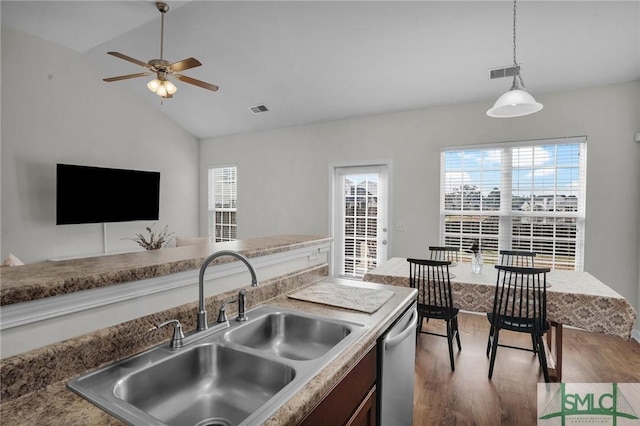 kitchen featuring wood finished floors, a sink, visible vents, stainless steel dishwasher, and pendant lighting