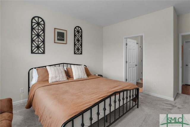 bedroom featuring baseboards and light colored carpet