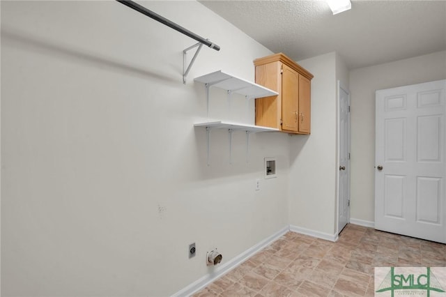 laundry room featuring washer hookup, cabinet space, hookup for an electric dryer, a textured ceiling, and baseboards