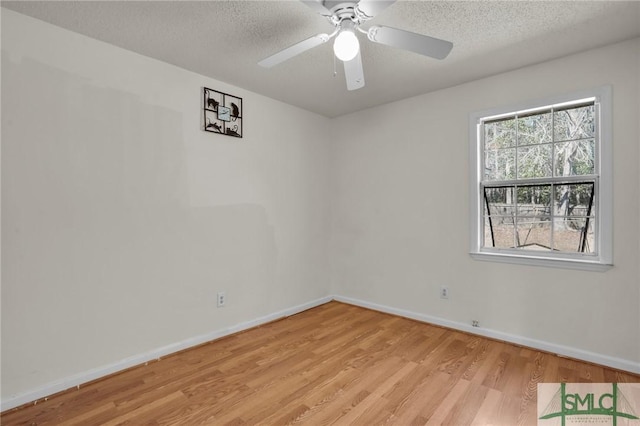 unfurnished room featuring a textured ceiling, light wood-type flooring, a ceiling fan, and baseboards