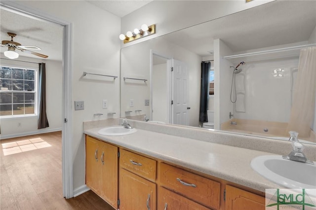 full bath featuring ceiling fan, toilet, shower / tub combo, wood finished floors, and vanity