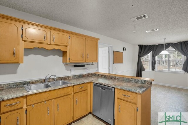 kitchen with a peninsula, stainless steel dishwasher, a sink, and visible vents