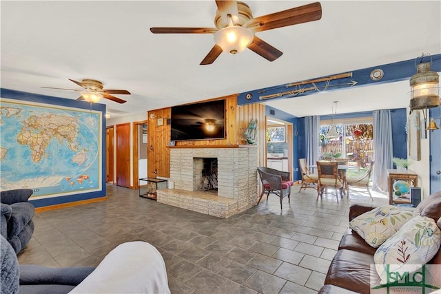 living area featuring ceiling fan and a brick fireplace