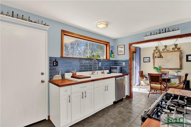 kitchen with black range with gas cooktop, white cabinetry, wooden counters, stainless steel dishwasher, and tasteful backsplash