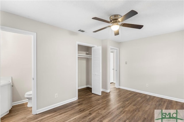 unfurnished bedroom featuring a closet, baseboards, and wood finished floors