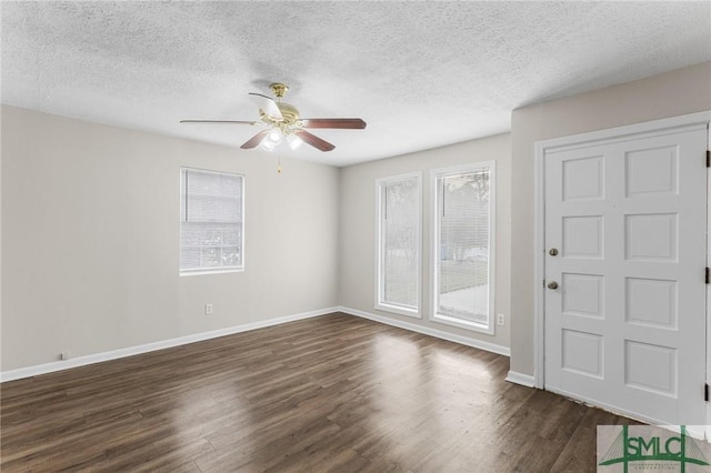 entryway featuring a textured ceiling, dark wood finished floors, a ceiling fan, and baseboards