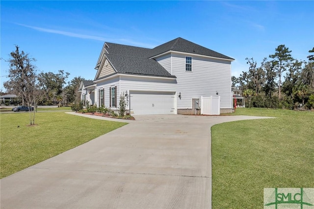 view of side of property featuring driveway, roof with shingles, an attached garage, and a yard