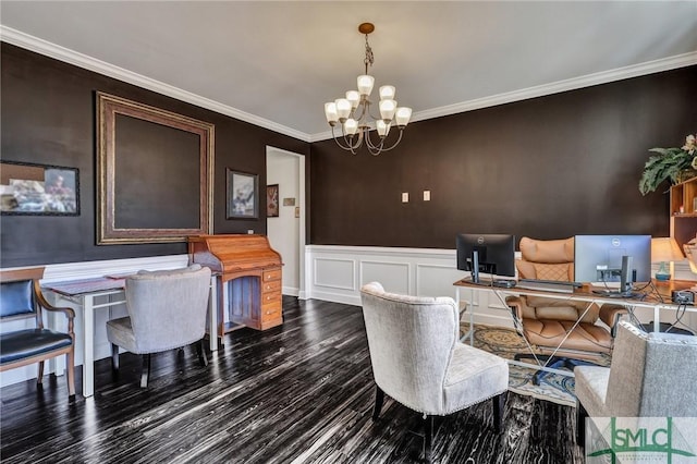 dining room with wainscoting, ornamental molding, a notable chandelier, and wood finished floors