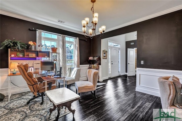 sitting room with visible vents, wainscoting, wood finished floors, crown molding, and a notable chandelier