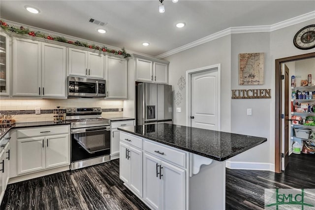 kitchen featuring visible vents, appliances with stainless steel finishes, dark wood finished floors, and crown molding