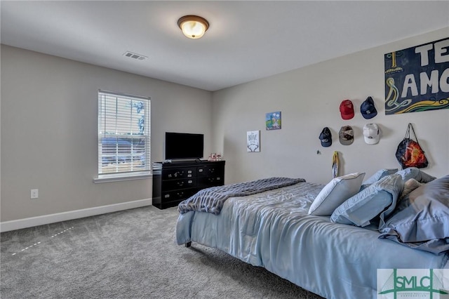 carpeted bedroom featuring visible vents and baseboards