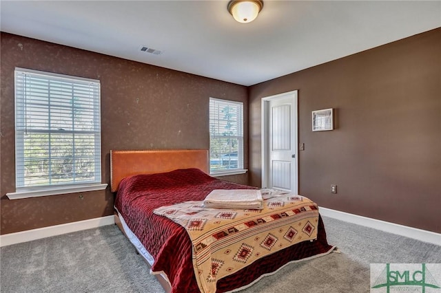 carpeted bedroom featuring visible vents and baseboards