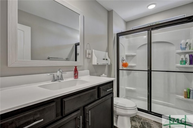 full bath featuring vanity, a shower stall, and toilet