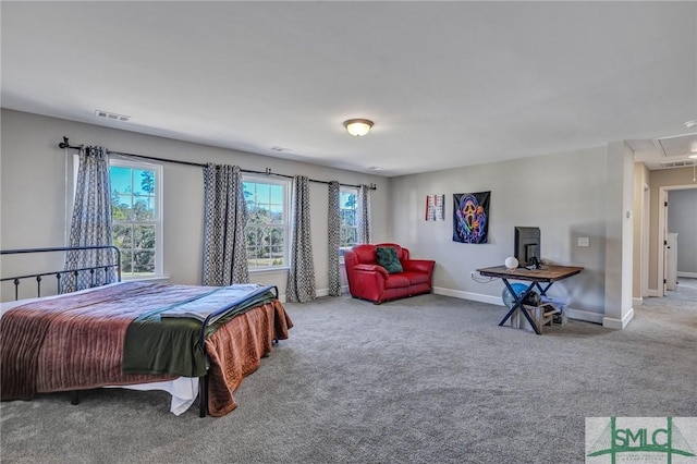 carpeted bedroom featuring visible vents, attic access, and baseboards