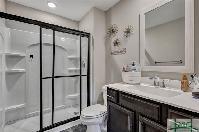 bathroom featuring a stall shower, vanity, and toilet