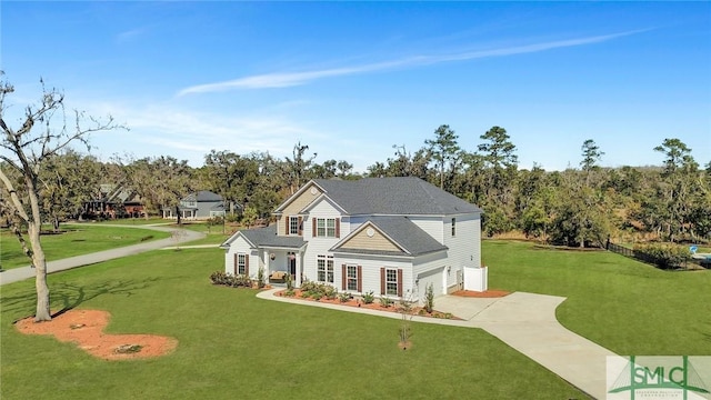 view of front facade featuring a garage, driveway, and a front lawn